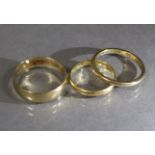 Two 9ct. gold plain bands, sizes: Q/R, & S, total weight: 4.5 gm; & an un-marked yellow metal