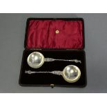 A pair of late Victorian silver apostle serving spoons, both depicting St. Peter, with writhen stems