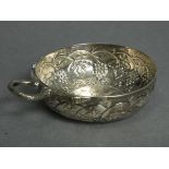 A French silver wine taster with serpent handle, the round bowl embossed with grapevines & inset