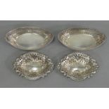 A pair of Edwardian silver boat-shaped sweetmeat dishes with beaded rims & pierced & embossed sides,