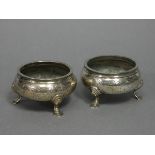 A pair of early Victorian silver squat round salt cellars in the mid-18th century style, each with