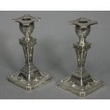 A pair of Victorian silver Adam-style desk candlesticks of square tapered form decorated with rams