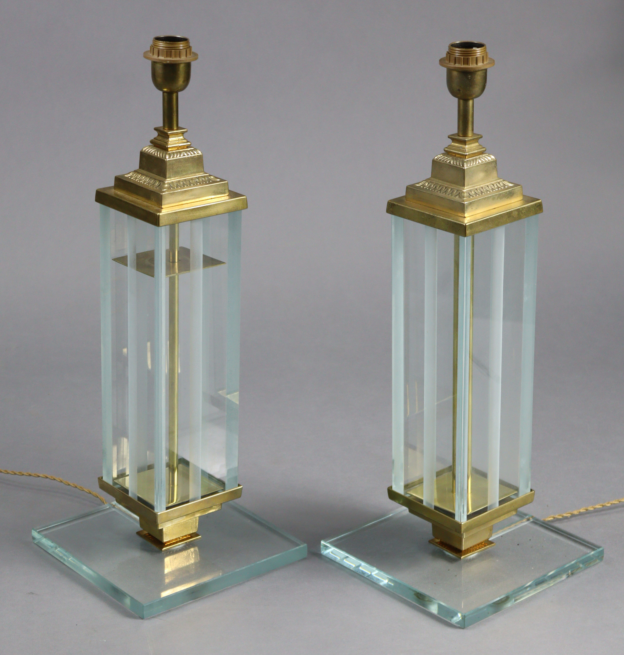 A pair of 20th century Italian brass table lamps on partially-frosted glass rectangular columns &