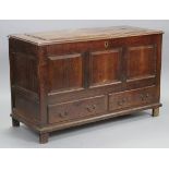 A late 18th/early 19th century oak coffer, with original hinges to the stepped lie, fitted till