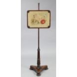 An early Victorian rosewood pole screen inset floral needlework banner, on carved & tapered column &