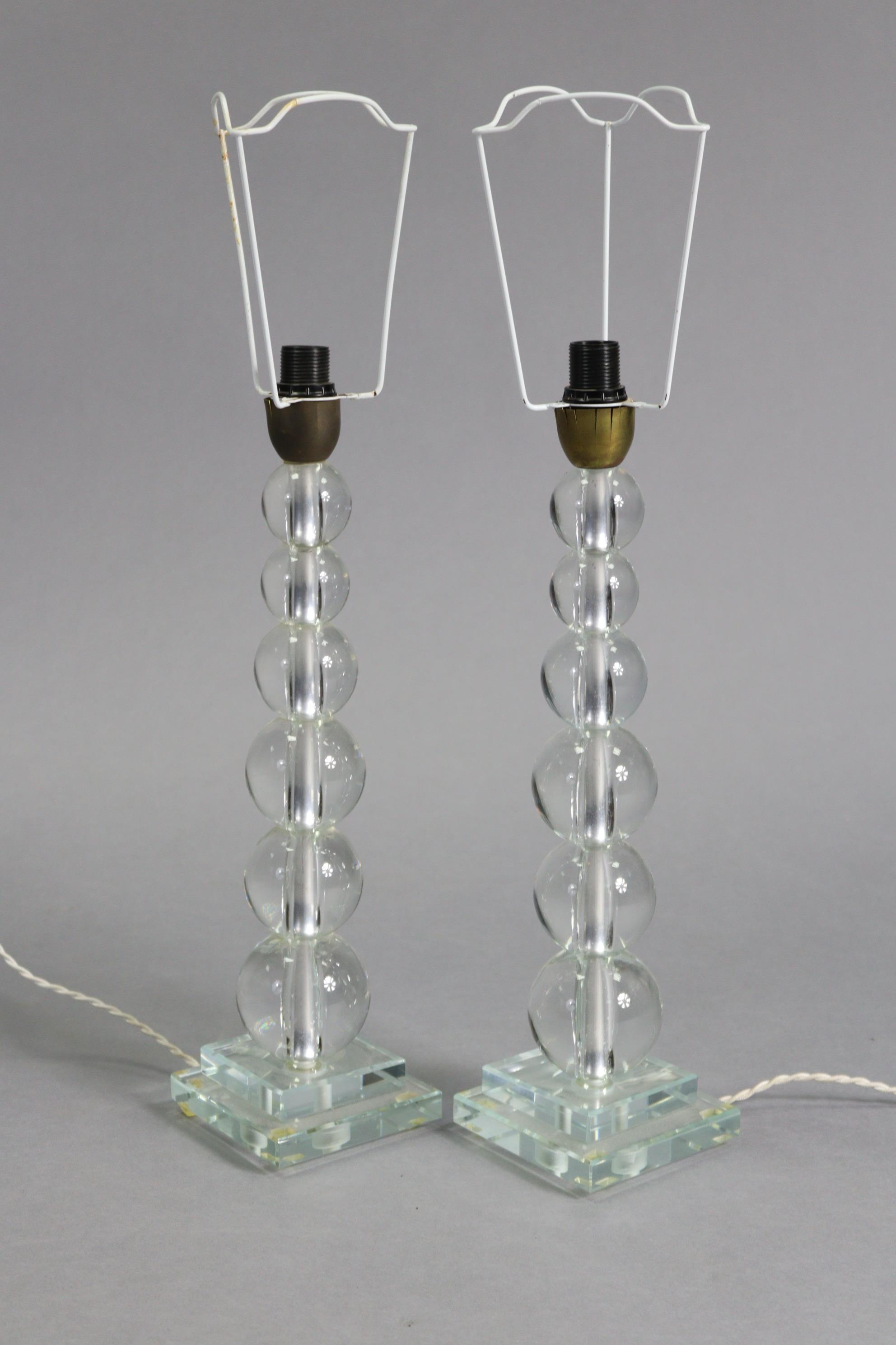 A pair of 20th century Italian clear glass table lamps on graduated ‘bobbin’ columns & square bases,