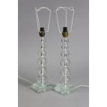 A pair of 20th century Italian clear glass table lamps on graduated ‘bobbin’ columns & square bases,