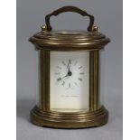 A modern Swiss small carriage timepiece by Matthew Norman, in oval gilt-brass case & with white