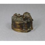 An eastern bronze inkwell in the form of a caparisoned elephant, with hinged circular cover; 3” wide