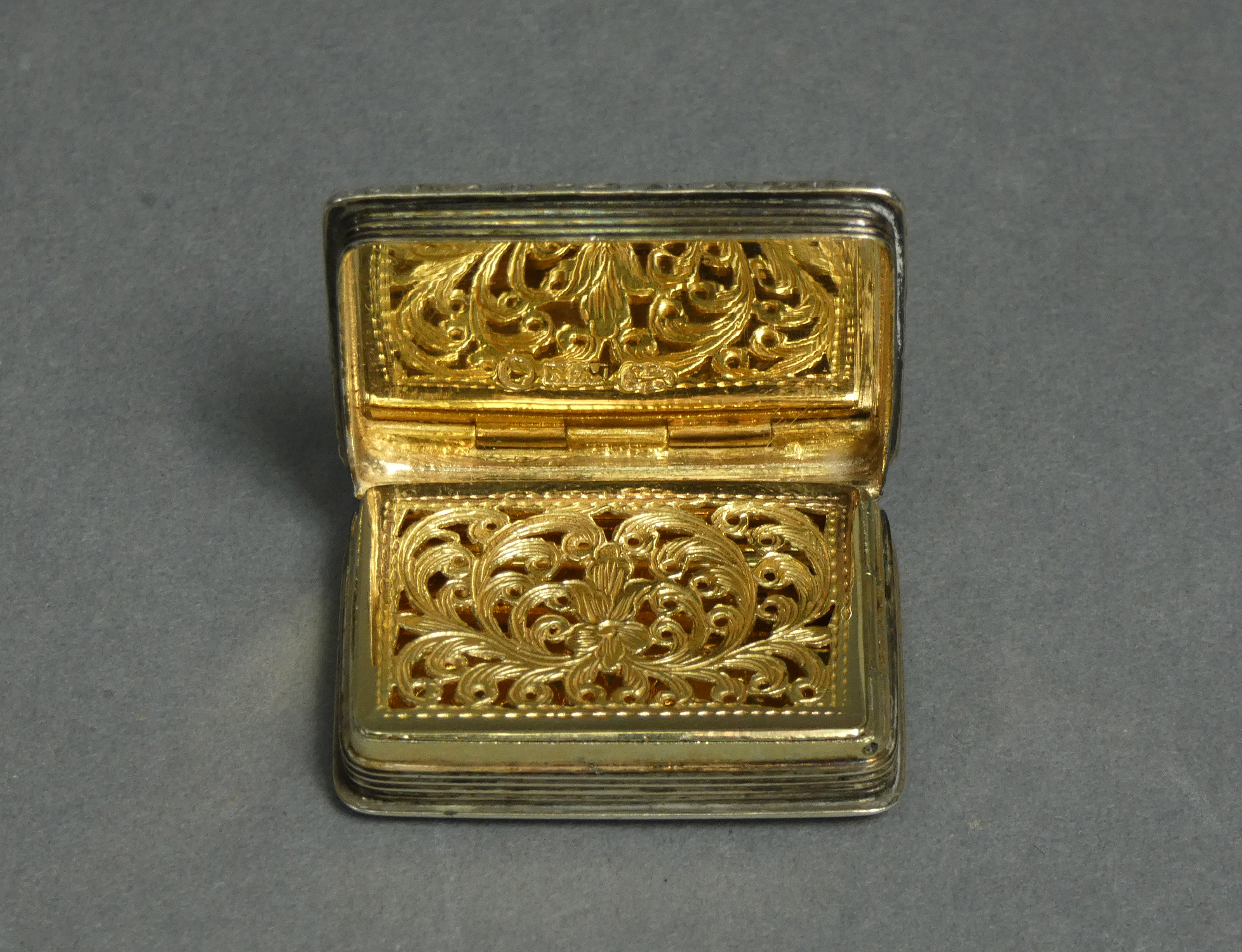 An early Victorian silver vinaigrette of rectangular shape, with engine-turned decoration & carved