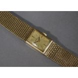 An Omega 9ct. gold ladies’ bracelet watch, the rectangular champagne dial with baton numerals, 17