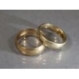 Two 9ct. gold plain bands; sizes: S & P, total weight: 9.4 gm.