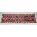 An Afghan runner of dark blue ground, with all over repeating geometric design & central row of four