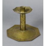 An Arts & Crafts brass candlestick of octagonal form, with planished surface & engraved decoration