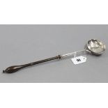 A George II punch ladle with oval bowl & turned wood handle, 13¼” long; London 1750, by William