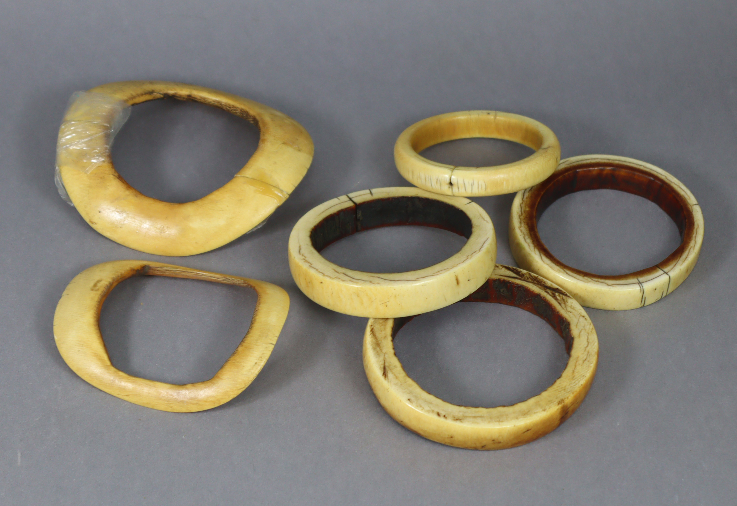 Six ethnic ivory bangles of various sizes.
