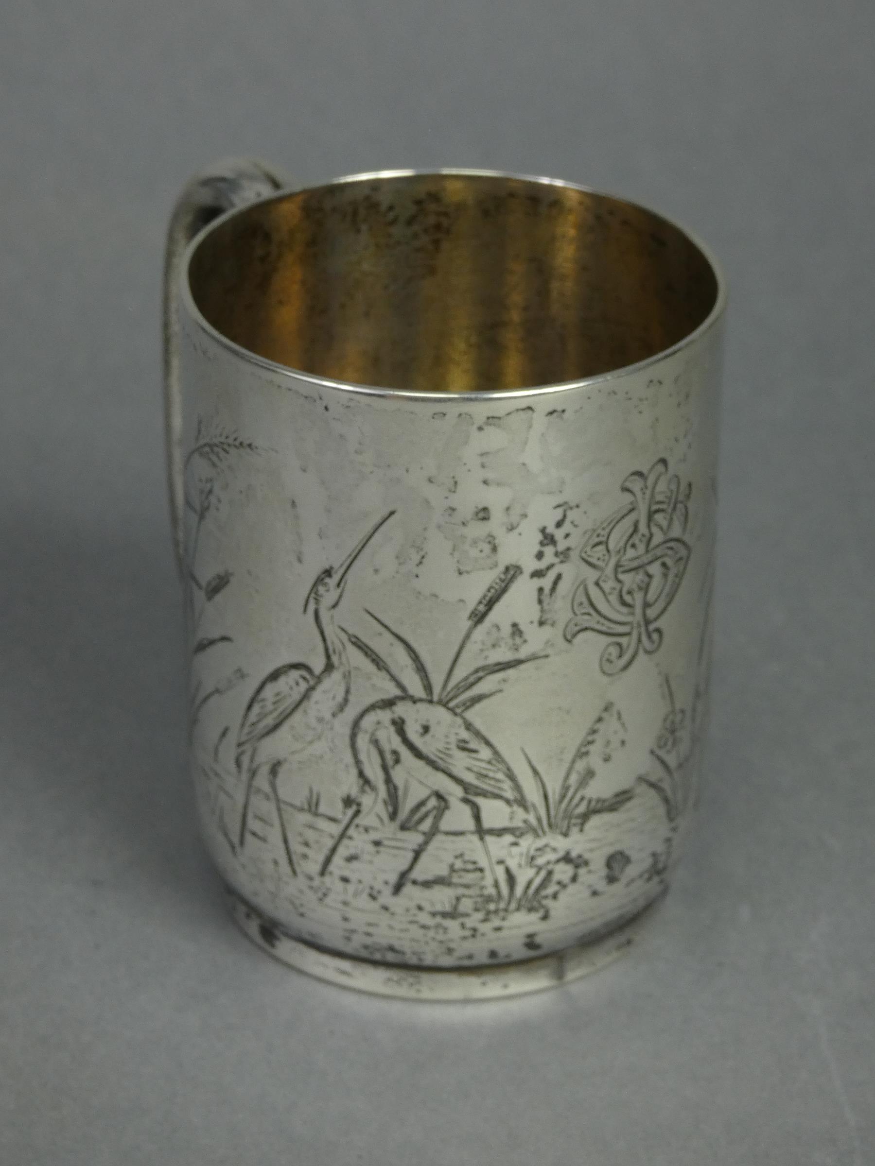 A Victorian silver half-pint mug of straight-sided form with engraved decoration of wading birds - Image 2 of 3