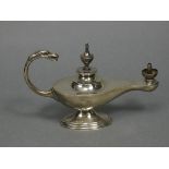 An Edwardian silver table cigar lighter in the form of a roman oil lamp with urn finial & mythical