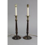 A pair of mahogany & brass table lamps, each with fluted tapering columns & round pedestal foot, 21”