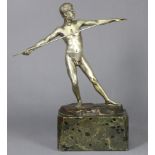 A silvered bronze sculpture of a javelin thrower, on rocky base signed “S. Schival Berg”, & on green