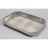 A rectangular two-handled tray with canted corners & pierced leaf-scroll gallery, on four fluted
