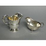 A Victorian silver helmet-shaped milk jug with scroll handle, & on round pedestal foot, 4” high,