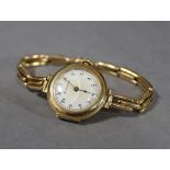 A ladies’ 15ct. gold bracelet watch, the circular white enamel dial inscribed: “Thos. Russell &
