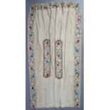 A pair of late 18th/early 19th century crewel-work curtains, of cream ground with multicoloured