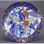 A Bursley Ware pottery charger designed by Charlotte Rhead, pattern No. 1420, decorated with flowers
