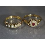 A late Victorian 18ct. gold ring set small ruby within a diamond border, Birmingham hallmarks for