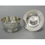 An Edwardian silver circular sugar bowl with beaded rim & all-over engraved foliate decoration to