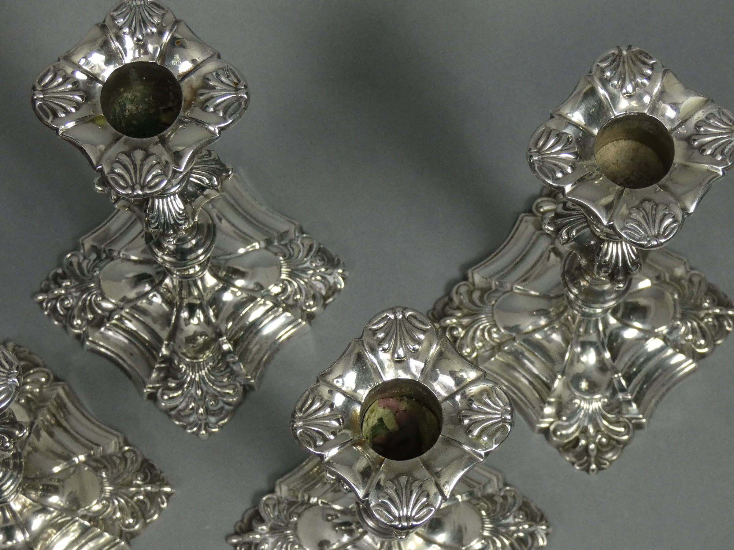 A set of four Edwardian silver candlesticks in the mid-18th century cast style, each with slender - Image 2 of 4