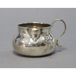 A George II provincial silver small cream jug of squat round form, with short neck & scroll side-