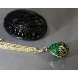 A silver-gilt & green guilloche enamel egg-shaped pendant locket, the lower part with foliage set