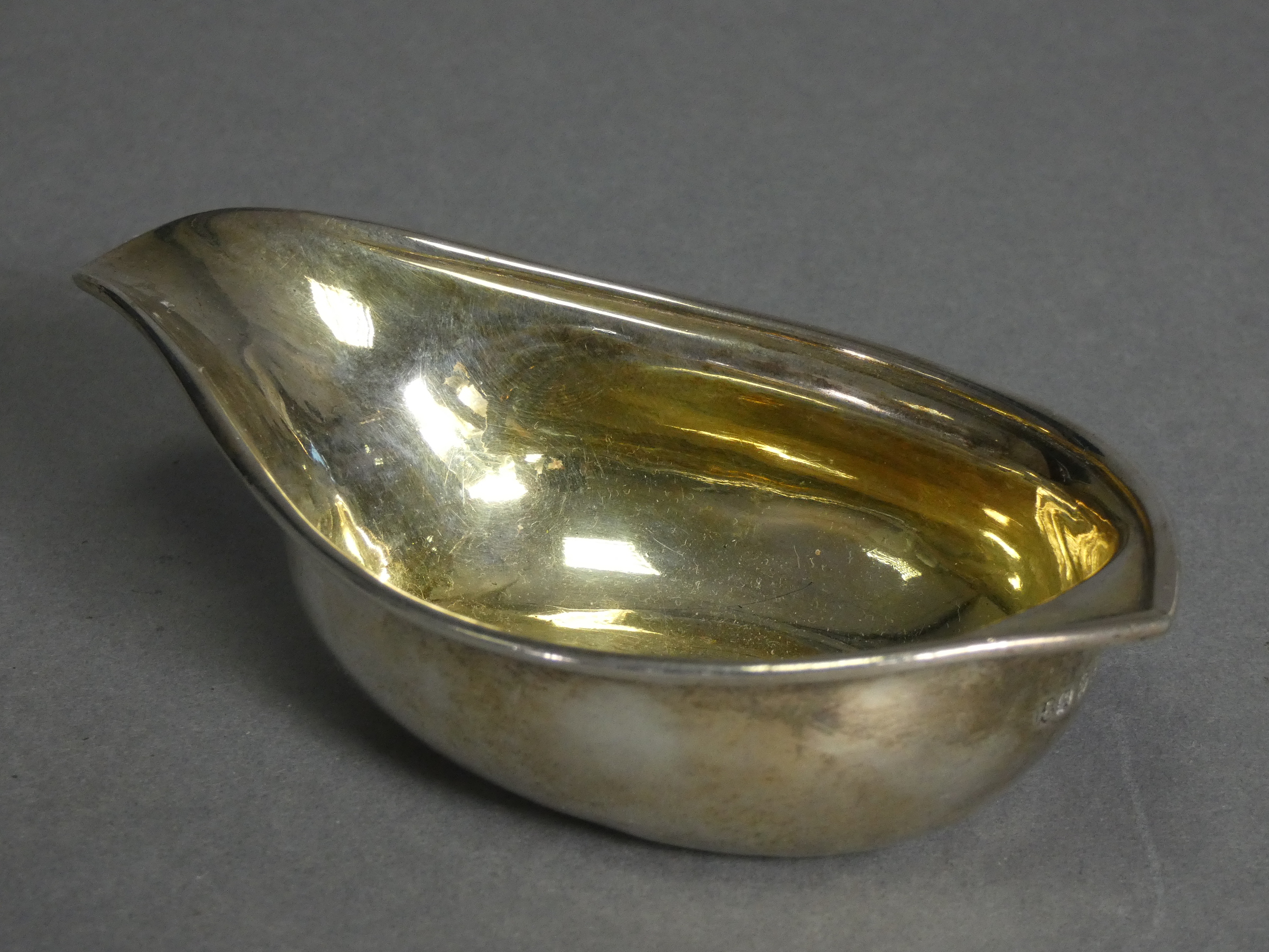 A George III silver pap boat with moulded rim, pointed end, & gilt interior, 5” long; London 1805, - Image 2 of 3