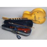 A Triumph six-string acoustic guitar; & a Mayflower child’s violin & bow, w.a.f., cased.