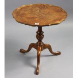 A reproduction walnut tripod table with moulded pie-crust edge to the circular top, & on vase-turned