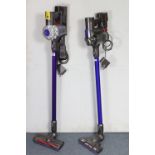 Two other Dyson cordless stick vacuum cleaners.