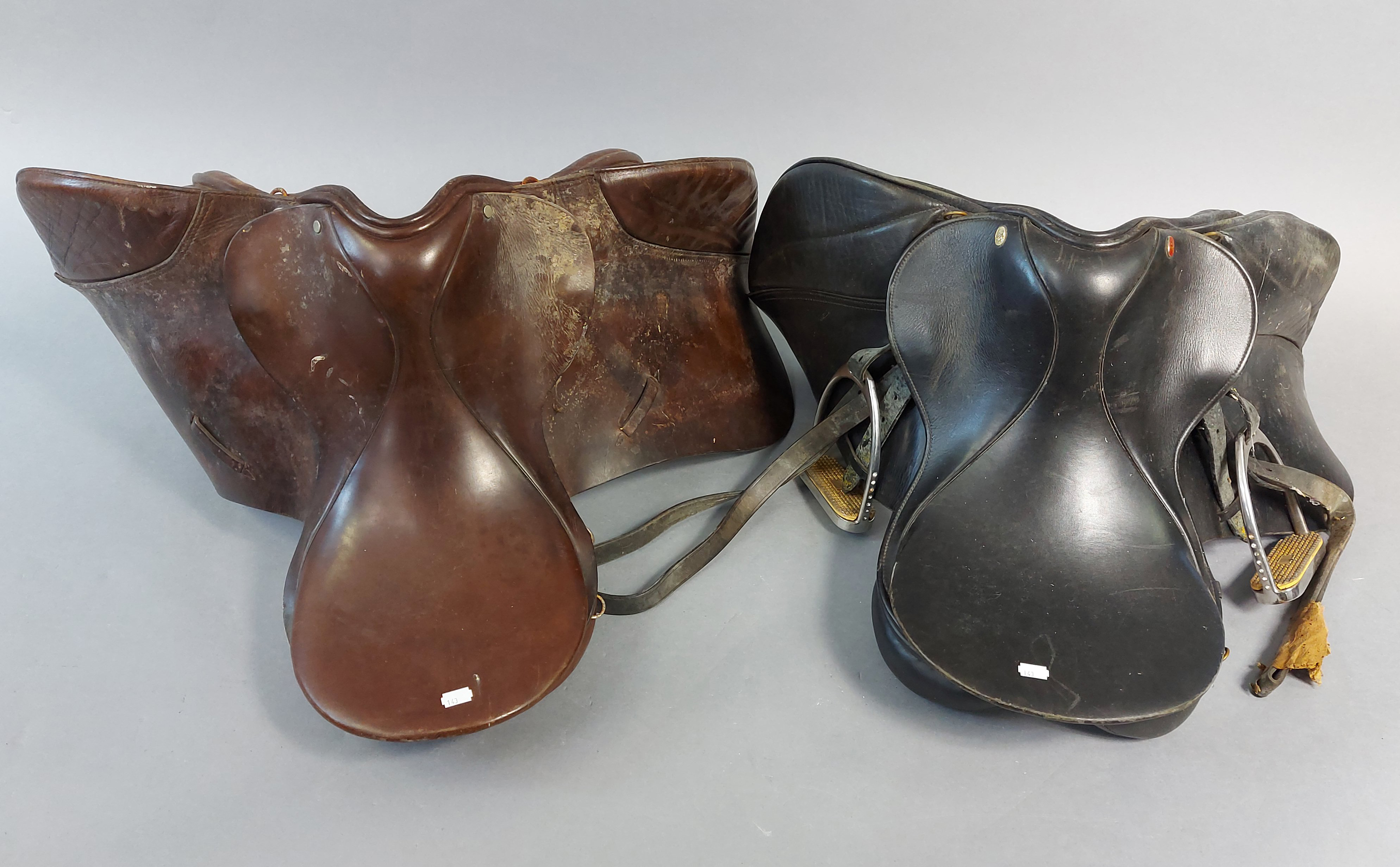Four tan leather horse-riding saddles, & various horse-riding reins, etc.