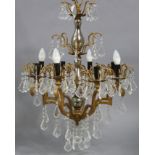 A 19th century-style gilt-metal & glass eight-branch chandelier with scroll-arms hung with prism
