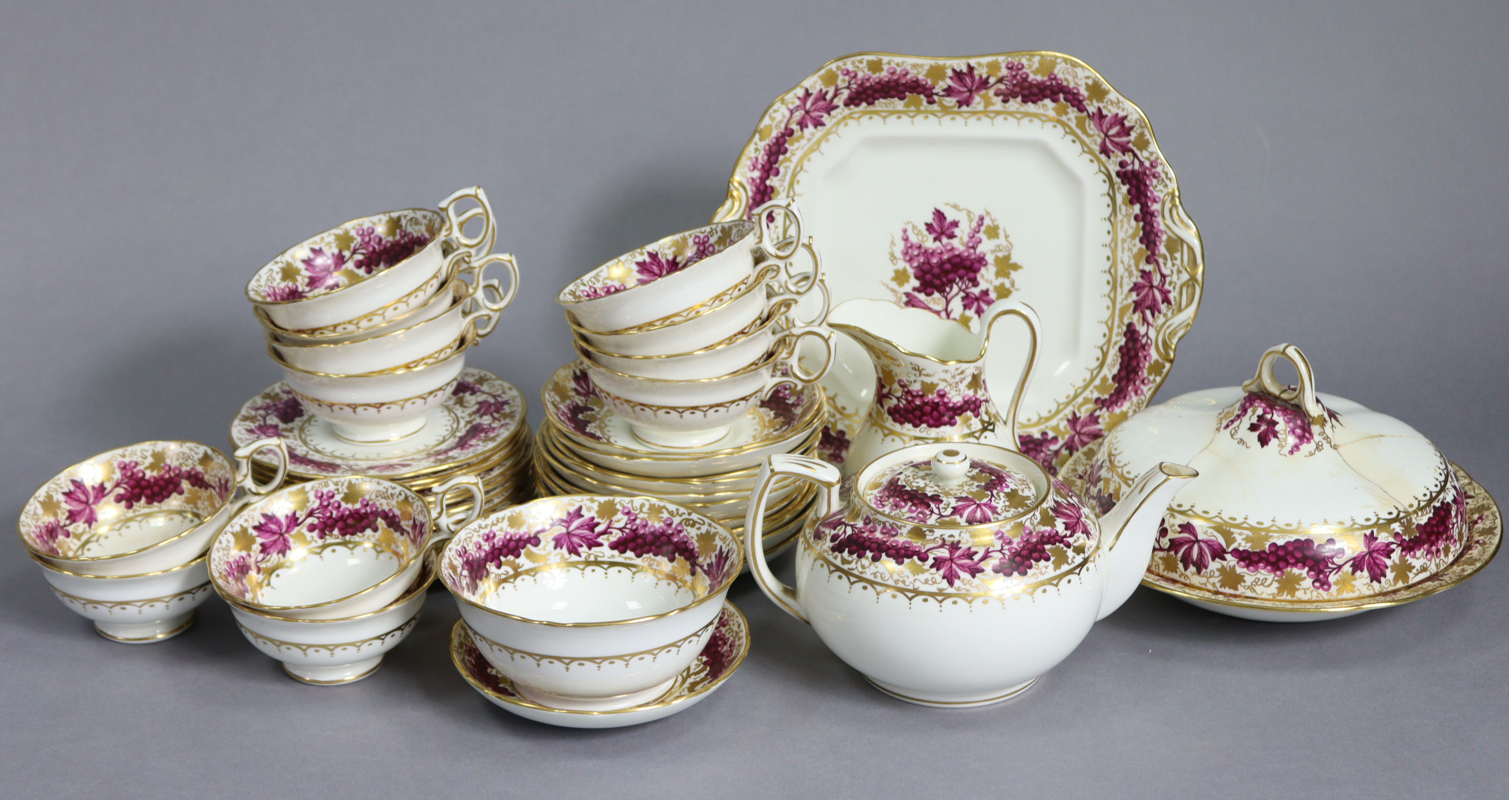 An early 20th century English porcelain tea service in the regency style, the wide borders decorated