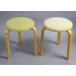 A pair of Artek (Finish) beech stools each on three legs & with padded seat, 14” diameter x 17¾”