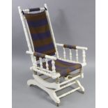A late 19th/early 20th century white painted wooden frame rocking chair on patent sprung base.