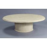 A contemporary cream marble low coffee table with oval top, & on an oval pedestal base, 53” wide x