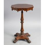 A 19th century rosewood tripod table with octagonal top, & on a vase-turned centre column & shaped