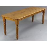 A pine farmhouse table, with rounded corners to the rectangular top, & on four turned legs, 83½”