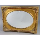 A 19th century-style gilt frame rectangular wall mirror, inset oval plate, 37½” x 27½”.