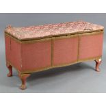 A pink painted Lloyd Loom-style serpentine-front ottoman with hinged lift-lid, & on short