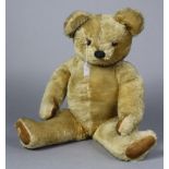 A mid-20th century Chad Valley golden plush growling teddy bear, with glass button eyes & with