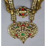 A yellow metal large pendant necklace set with numerous coloured paste stones, 15½” long (the